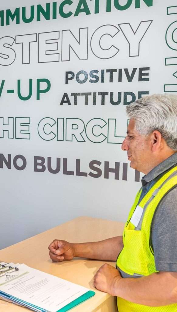 Alpine Tree Care team member discussing tree service compliance and permitting with a client at the office